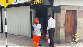 A CHOLONA CLEANING WORKER GETS UP, LIMA-PERU