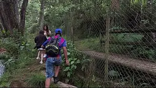 Threesome in the woods with two pretty girls .